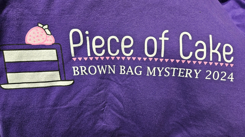 Piece of Cake Brown Bag Mystery 2024 Purple V-Neck T-Shirt