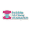 Bobbin Chicken Champion sticker with a pink and aqua spool and aqua lettering