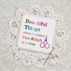 One Stitch at a Time sticker with multicolor lettering, pink scissors, and stitched border