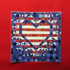 Patriotic Exploding Heart sticker with a striped red and white heart in navy quilt blocks