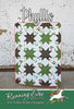 Phyllis quilt pattern cover with green and black stars and red floral blocks on white