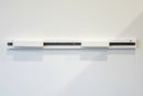 White quilt hanging system on a white wall