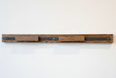Oak stained quilt hanging system on a white wall
